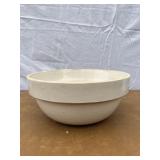 White stoneware mixing bowl has a crack in the sid