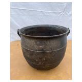 Cast iron footed kettle with 5 holes in the bottom