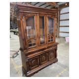 Wooden china cabinet with a hutch top and a