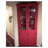 Red corner cabinet. Contents not included