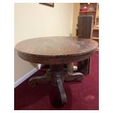 Antique round dining table with two leaves. On