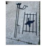 Two shepherds hooks and pheasant on gate