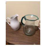 Two pitchers. Glass one appears to be very old