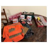 Hunting vest, shotgun shells, gun cleaning kit