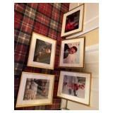 Five pieces of wall art including men with bagels