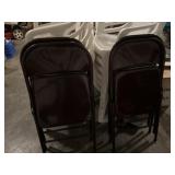 Four brown folding chairs