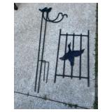 Two shepherds hooks and pheasant on gate