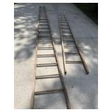 Two old wood ladders. One is 14 foot and one is