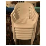 Six white plastic outdoor chairs