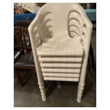 Six white plastic outdoor chairs
