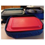 Three Pyrex baking dishes with lids and cases
