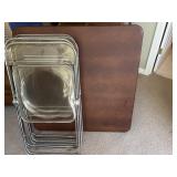 Four clear plastic chairs, and card table