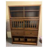 Shelving unit with doors that slide in the middle