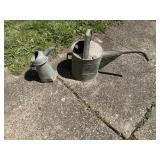 Vintage metal watering can and oil can. Both have