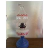 Antique floral kerosene lamp with blue pedestal