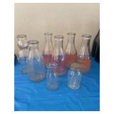 Vintage milk bottles, including Roths, two