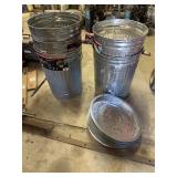 Galvanized trash cans. Notice the two have holes