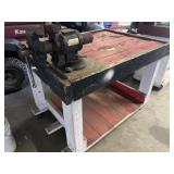 Vice on work table on wheels. Work table is