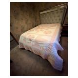 Handmade hand, quilted pink and white quilt.