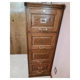 Wooden four drawer file cabinet glass items on
