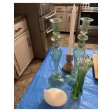 Small hand on nest, candleholders, and vase as