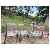 Four outdoor chairs and two side tables