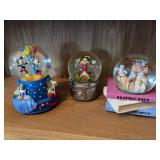 Three musical snow globes