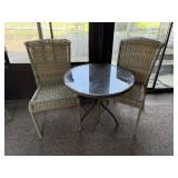 Round glass topped bistro set. Resin wicker