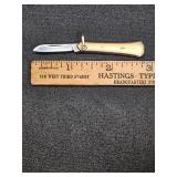 * Brass colored pocket knife with bail loop