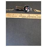 * Jabot pin, Swank tie bar, hand saw charm