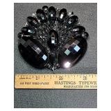 * Large black brooch