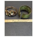 * Gold toned and green cuff bracelets