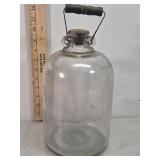 Antique glass jug with wood handle moonshine