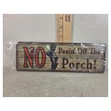 No peeing off the porch metal sign
