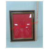 Frame with red felt background made for Norman