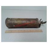 Old brass fire extinguisher with holder