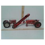 Two metal tractors and metal conveyor