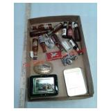 Belt buckles, beer bottle salt and pepper shakers