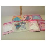 Several Barbie doll outfits new in box