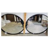 Two circular wall mirrors