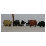 4 pig statuettes