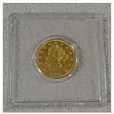 Gold colored piece of metal stamped 1883
