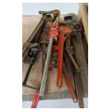 Pipe wrenches and clamps