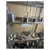 Assorted Pots and Pans Pictured On Rack