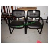 (2) Black matching arm chairs in group
