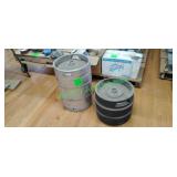 Two kegs, one constructed of stainless steel and t Two kegs, one constructed of stainless steel and t