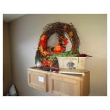 Fall decor items & wood storage cabinet on wall