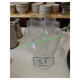 7 plastic pitchers in group