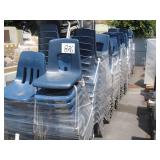 ROW OF BLUE PLASTIC SCHOOL CHAIRS