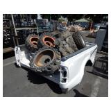ONE FORD TRUCKBED WITH MISCELLANEOUS TRACTOR TIRES